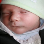 tucked up under Poppy in the pram (Here’s how Joe travels)