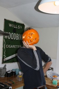 Pumpkin Head chills in the kitchen.